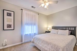 a bedroom with a bed and a ceiling fan at Idyllic Pasadena Retreat with Garden and Hot Tub! in Glen Burnie