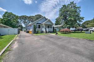 a house with a dog walking down a driveway at Idyllic Pasadena Retreat with Garden and Hot Tub! in Glen Burnie