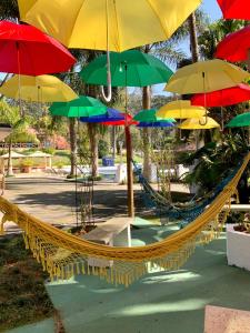 a hammock with colorful umbrellas on top of it at Pousada Serra das Araucárias in São Roque