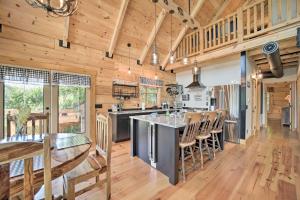 a kitchen and dining room with wooden walls and ceilings at Luxe Log Cabin with Modern Finishes and Mtn Views in Maggie Valley