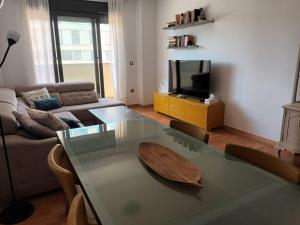 a living room with a glass table and a couch at LUCIA S HOUSE in Mairena del Aljarafe