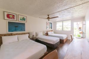 Ένα ή περισσότερα κρεβάτια σε δωμάτιο στο SCP Hilo Hotel