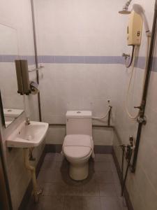 a bathroom with a toilet and a sink at T Hotel Anggerik in Alor Setar