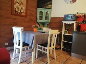 a kitchen with a table with three chairs and a table and a kitchen with at Vibrant holiday home in Villanueva with terrace in Villanueva