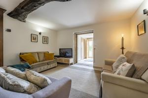 a living room with two couches and a tv at Nomad's Country - 4BED Casa de Macieira in Santa Maria Da Feira