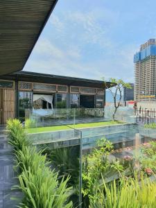 a glass extension of a building with plants at Minh Boutique in Danang