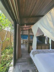 a bedroom with a bed with a canopy and a table at Minh Boutique in Danang