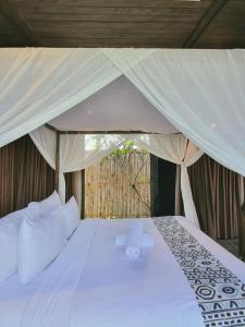 a bedroom with a white bed with a canopy at Minh Boutique in Danang