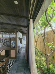 an outdoor room with a canopy and a tree at Minh Boutique in Da Nang