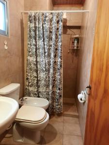 a bathroom with a toilet and a shower curtain at del PARANA in Corrientes