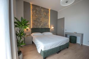 a bedroom with a bed with a painting on the wall at Albergo Ristorante Il Terziere in Trevi