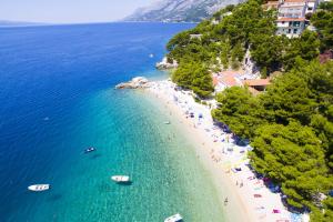 an aerial view of a beach with people and boats at Apartments by the sea Brela, Makarska - 11821 in Brela