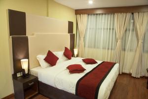 Una cama o camas en una habitación de Hotel Meridian Suite