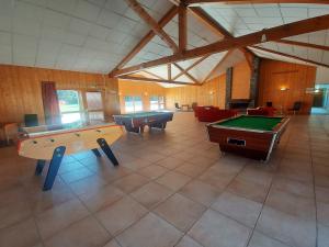 a large room with two pool tables and couches at Appartement Samoëns, 2 pièces, 6 personnes - FR-1-624-117 in Samoëns