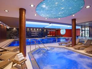 a swimming pool with a large blue tub in a hotel at Hotel Vitality in Vendryně
