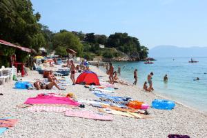 a group of people laying on a beach at Apartments with a parking space Gradac, Makarska - 15628 in Gradac
