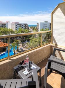 a balcony with a table and chairs and a view of the ocean at H10 Salou Princess in Salou