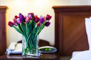 a vase filled with flowers on top of a table at Best Western London Ilford Hotel in Ilford
