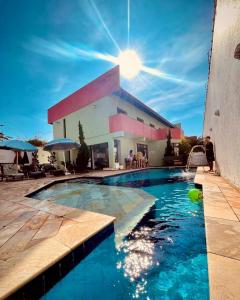 a swimming pool in front of a building at Hostel e Pousada Bahia Beach in Itanhaém