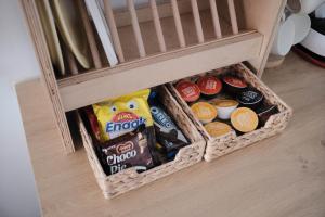 a basket of food and other snacks in a crib at Privacy Home in Tainan