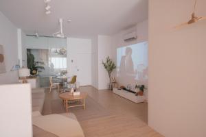 a living room with a couch and a table at Privacy Home in Tainan