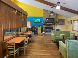 a restaurant with tables and chairs and a fireplace at America's Stay Inn Stewartville in Stewartville