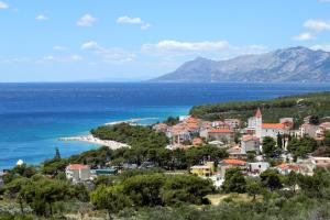 a town on a hill next to the ocean at Studio Promajna 2605a in Promajna +9 photos
