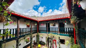 a building with a balcony with flowers on it at Hotel San Gabriel in El Cocuy