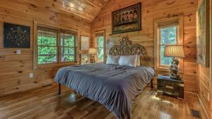 Un dormitorio con una cama en una cabaña de troncos en Endless Echo, en Blue Ridge
