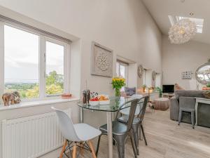 a kitchen and living room with a table and chairs at Ivy Cottage in Chester