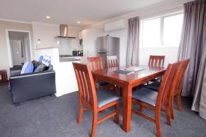 a kitchen and dining room with a wooden table and chairs at Ashley Heights in Lake Tekapo