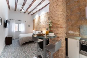 a bedroom with a bed and a table in a room at Tosca 2 PAX by costablancarent in Denia