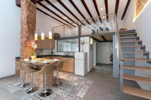 a kitchen and dining room with a staircase and a table at Suite Loft 4 PAX by costablancarent in Denia
