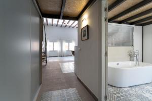 a bathroom with a white tub and a sink at Suite Loft 4 PAX by costablancarent in Denia