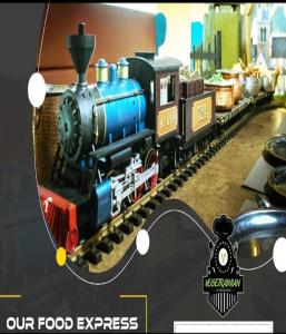 un tren de juguete en una pista con una foto en Hotel Hallmark By THC Group en Kota