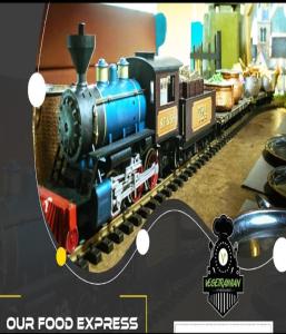 a toy train on a track with a picture at Hotel Hallmark By THC Group in Kota