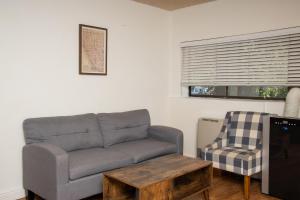 a living room with a couch and a chair at The Occidental Lodge in Occidental