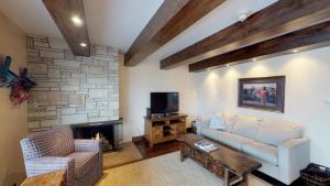 a living room with a couch and a fireplace at Luxury 2 Bedroom Lionshead Village Condo, Short Walk To Gondola in Vail