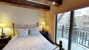 a bedroom with a bed and a large window at Luxury 2 Bedroom Lionshead Village Condo, Short Walk To Gondola in Vail