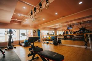 un gimnasio con un montón de equipos de ejercicio en una habitación en Beach Garden Hotel en Saipan