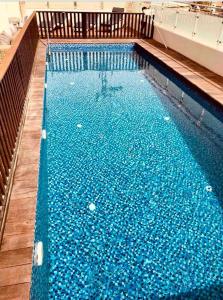 a large swimming pool with blue water at Glamour Luxury Suite Swimming pool in Eilat
