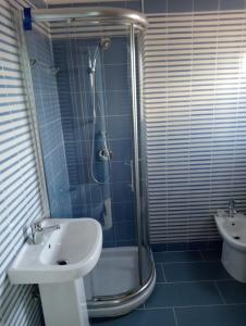 a bathroom with a shower and a sink and a toilet at Cala Licina in Agropoli