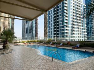 a swimming pool in a city with tall buildings at One bedroom apartment with pool & gym near Marina in Dubai
