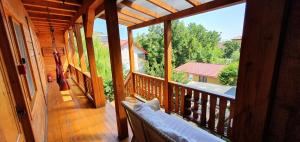 a balcony of a house with a couch on a porch at Casa Moața La Vama Veche in Vama Veche