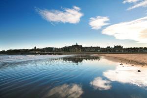 
a beach scene with a large body of water at Agnes Blackadder Hall - Campus Accommodation in St. Andrews
