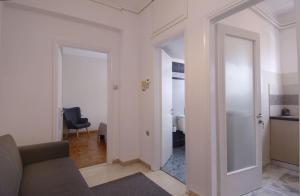 salon z kanapą i otwartymi drzwiami w obiekcie MAHE APARTMENT w mieście Wolos +21 zdjęć
