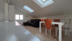 a living room with a white table and orange chairs at Casa Vacanze "Machí" in Senigallia