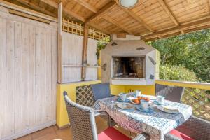 a table and chairs on a patio with an outdoor oven at Apartments Vivijana in Rabac +42 photos