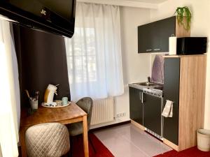 Televízia a/alebo spoločenská miestnosť v ubytovaní Bed & Rooms, Wörgl