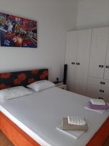 a bedroom with a large white bed with two pillows at Kuća za odmor Leptirić in Pisak +68 photos